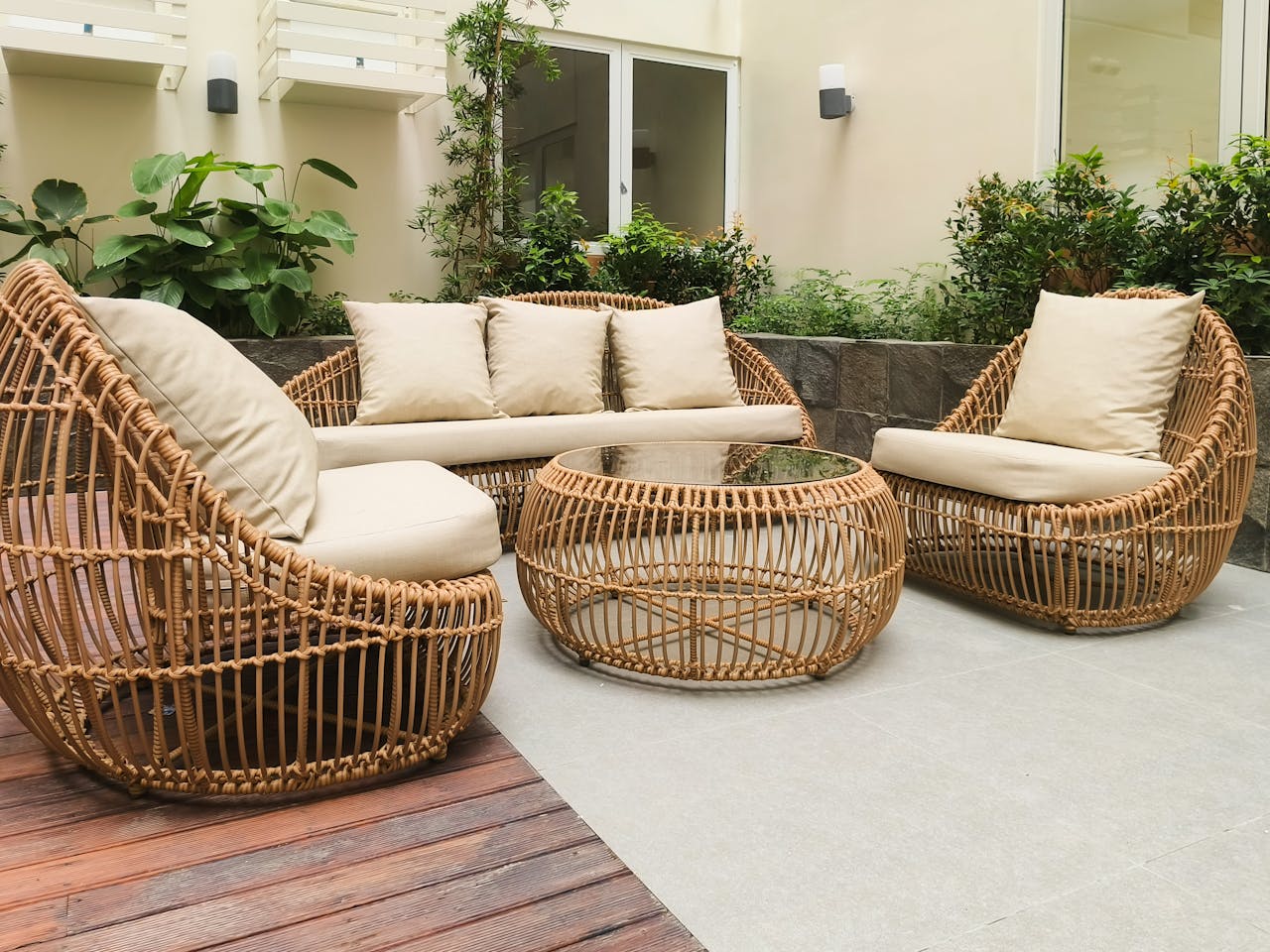 services-04 Outdoor seating with rattan furniture set in a lush garden patio, ideal for relaxation and gatherings.