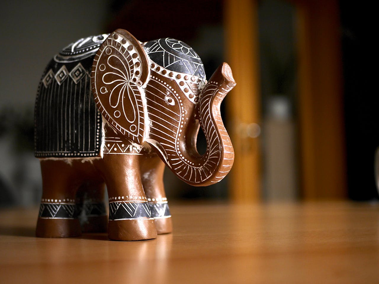 services-02 Elegant handcrafted wooden elephant figurine with intricate carvings, adding artistic charm to any room.